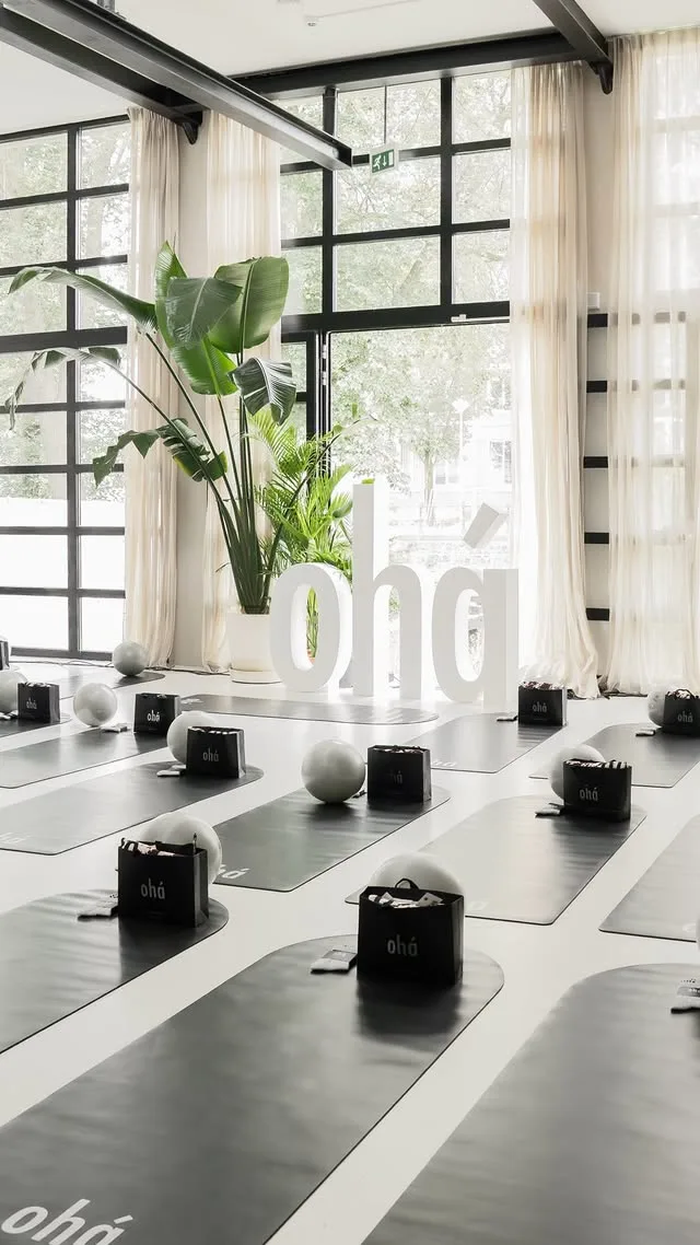 The ohá event room, ready — forty mats, goodie bags and the white ohá letters